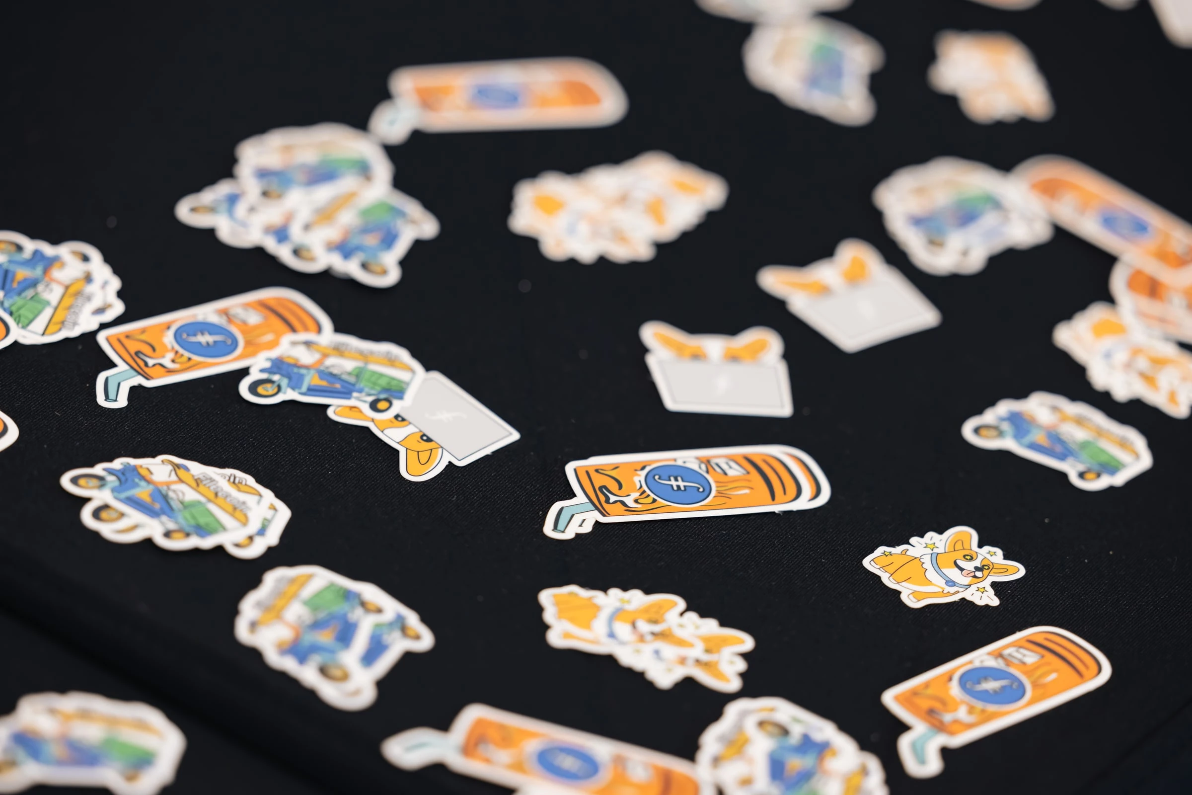 FIL Bangkok stickers scattered on a black table