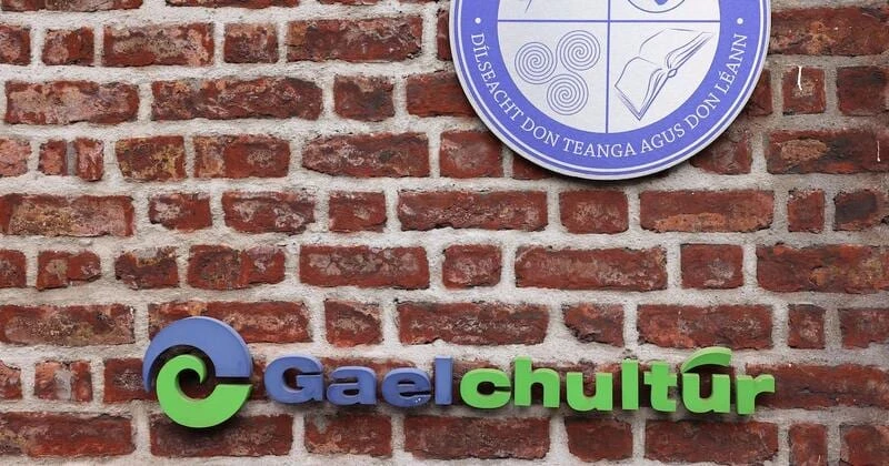The Gaelchultúr sign — an Irish-language school — mounted on a red-brick wall